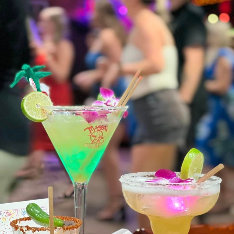 a person sitting at a table with wine glasses