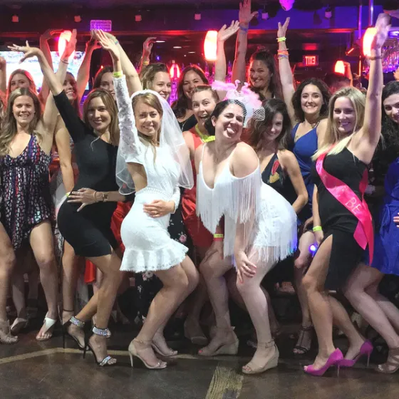 a group of people standing in front of a crowd posing for the camera