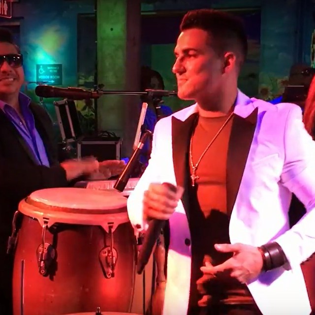 a man and a woman standing in front of a cake